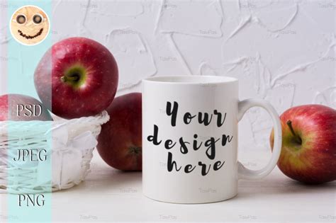 Download White coffee mug mockup with red apples in wicker basket